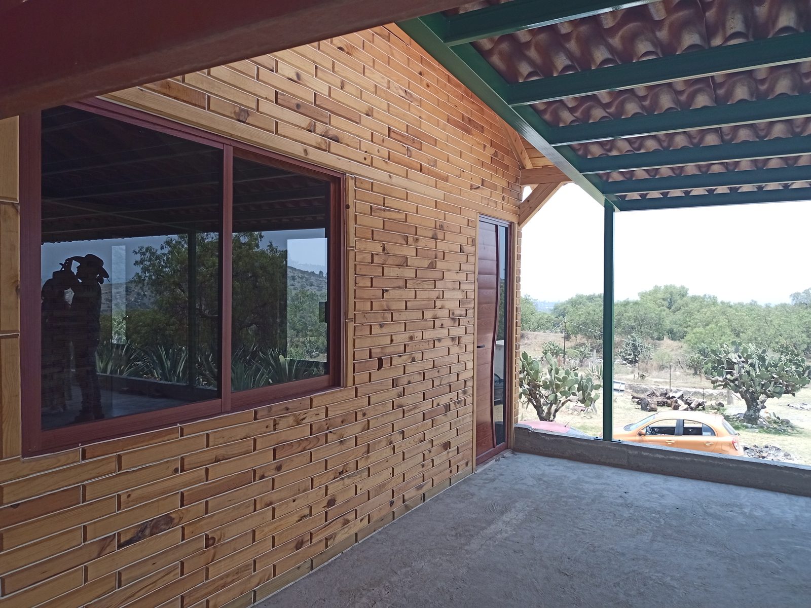 Silver Model timber cabin — covered terrace with countryside view